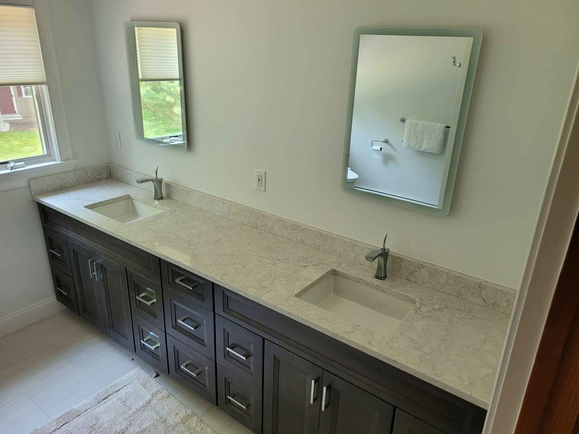 A bathroom with two sinks and two mirrors.