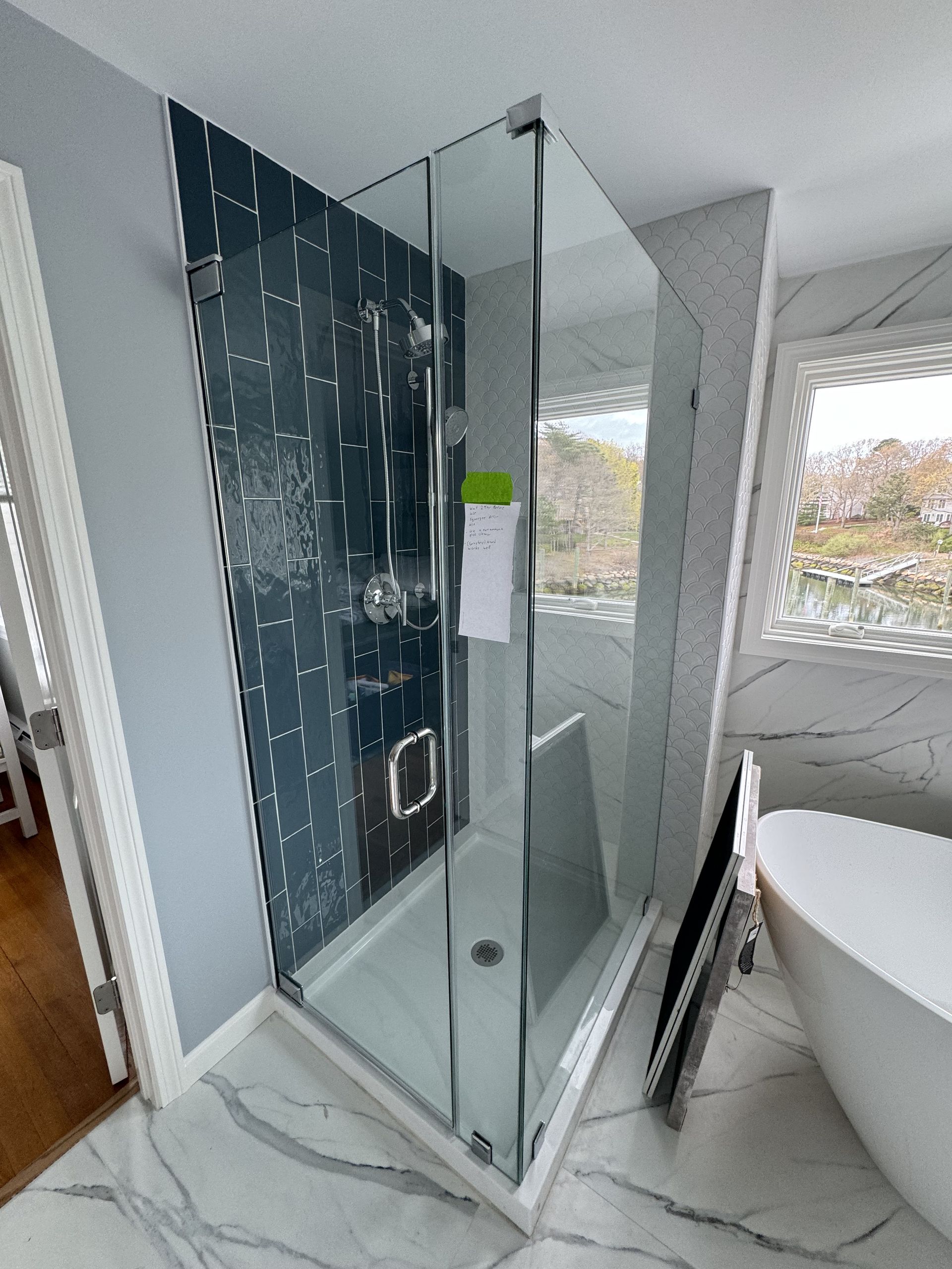 A bathroom with a walk in shower and a bathtub.