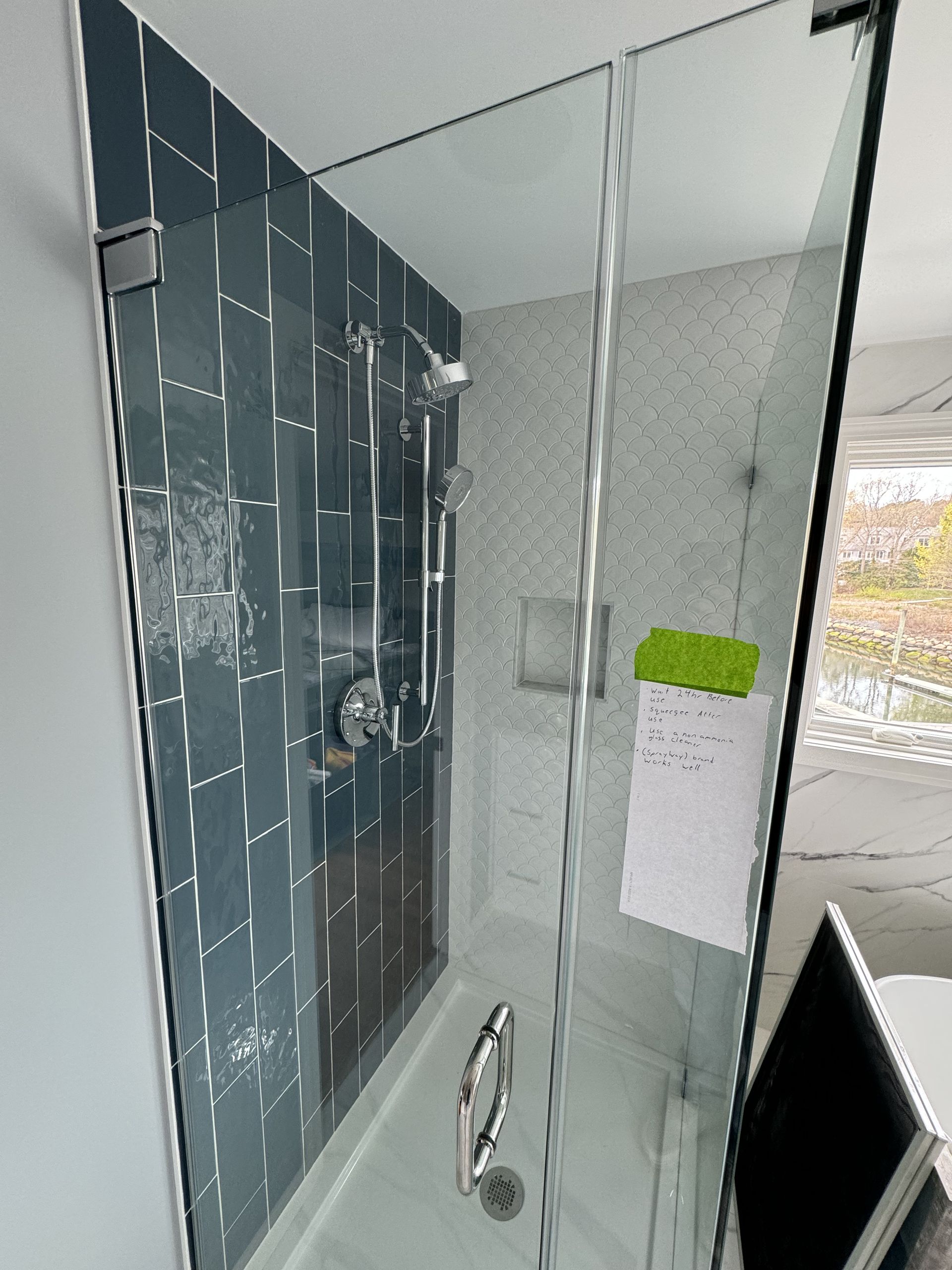 A bathroom with a bathtub and a shower with a glass door.