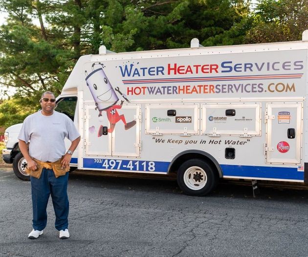 Man standing beside a Water Heater Services truck with logo and website printed on the side