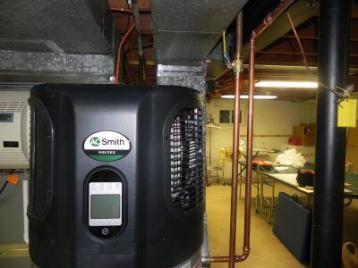 Black Smith HVAC unit in a basement utility room with copper pipes and ductwork.