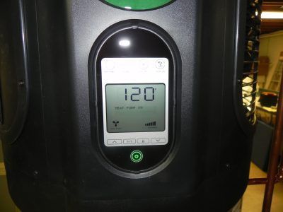 Close-up of a black device display showing 120, with a green button below it.