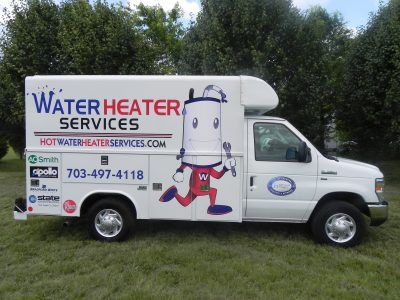 White Water Heater Services van with cartoon water heater logo parked on grass, trees in background