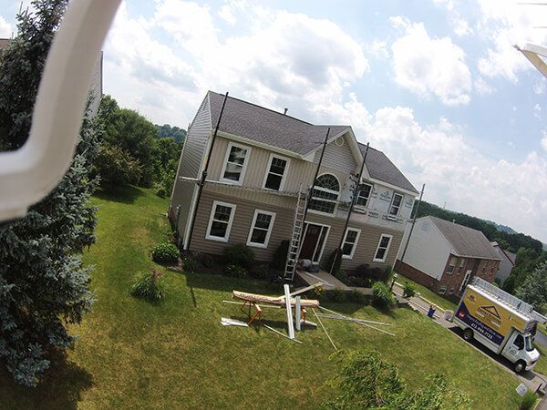 An aerial view of a house with a truck parked in front of it.