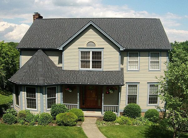 A large house with a gray roof and lots of windows