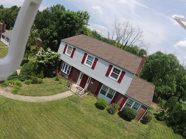 An aerial view of a house with red shutters