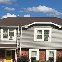 A house with a ladder attached to the side of it.