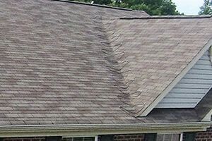 A close up of a roof of a house with shingles on it.