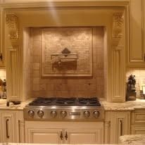 Stainless steel range with tile backsplash in a kitchen.