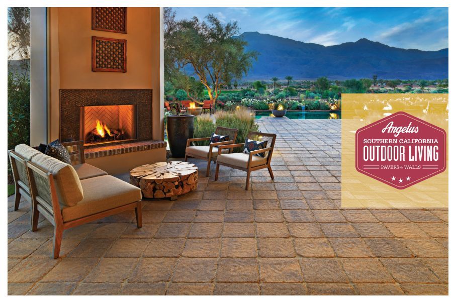 Outdoor patio with fireplace, seating, and mountain view.