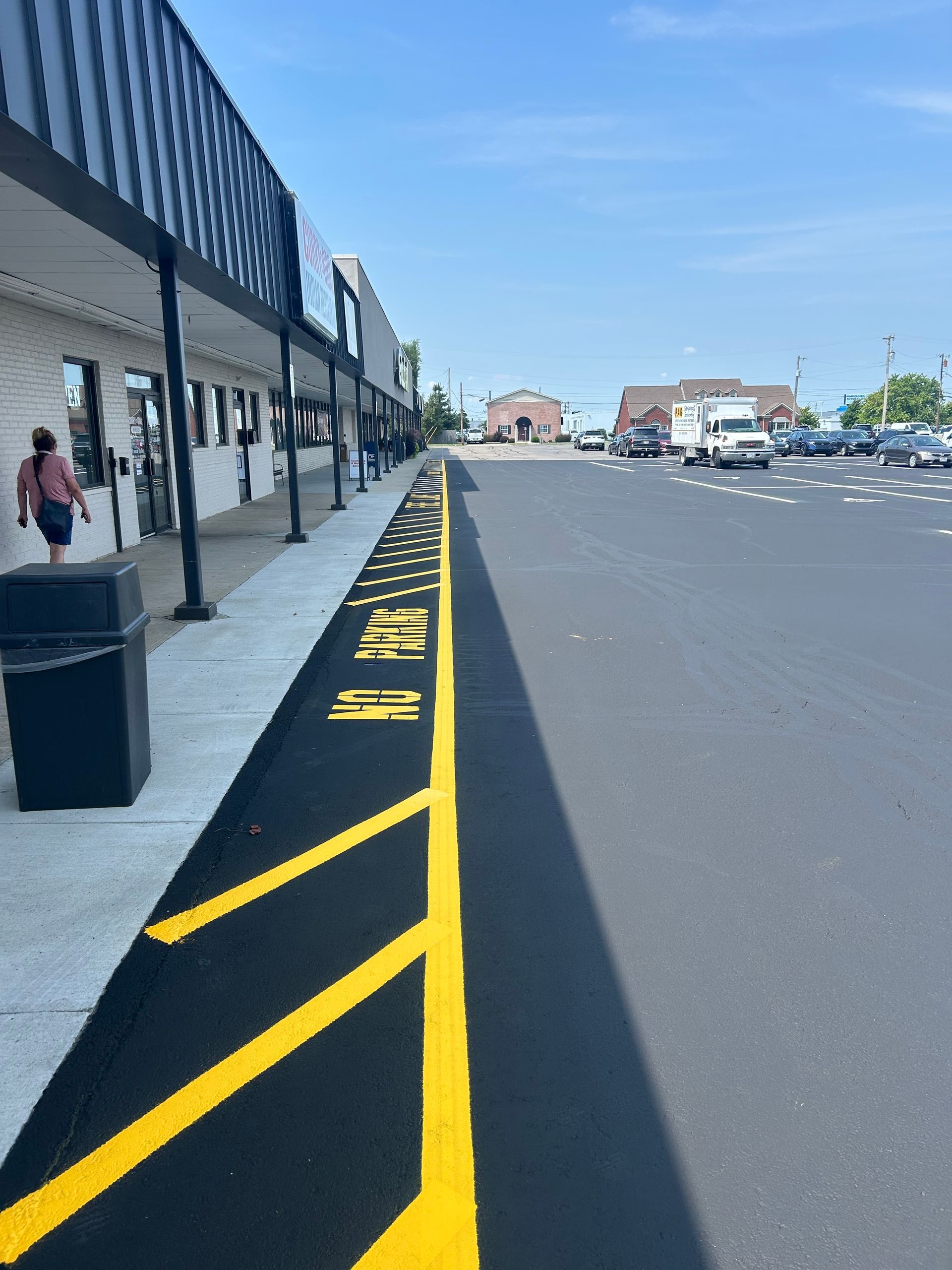 A walkway outside a commercial building with yellow 