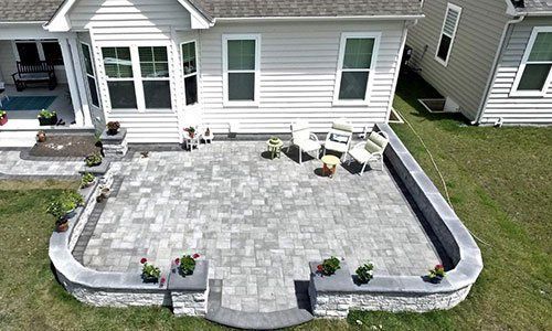 An aerial view of a patio in front of a house.