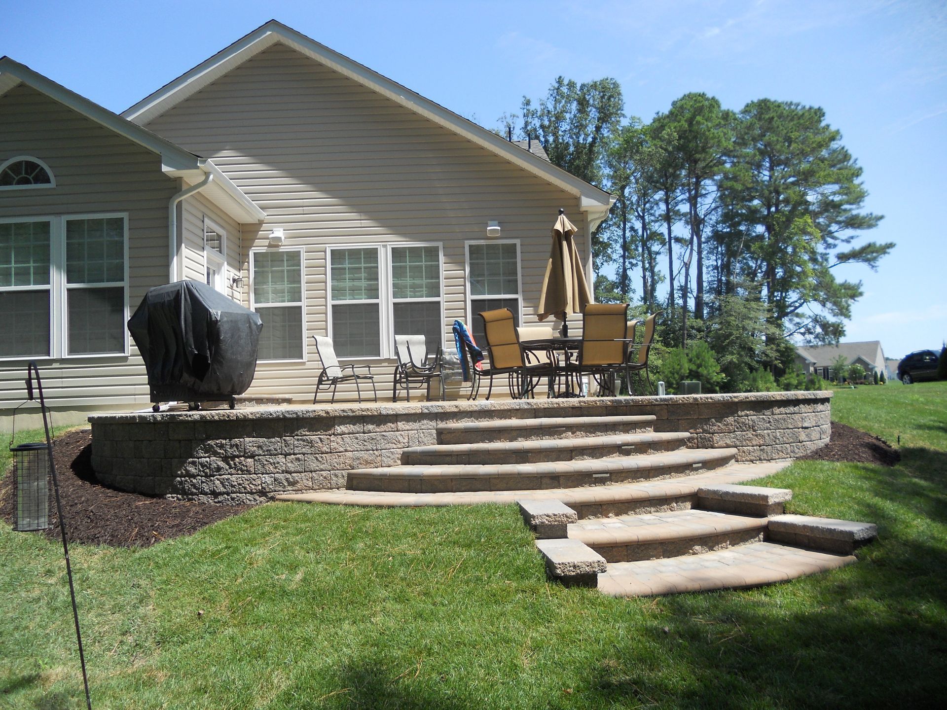A house with a patio and stairs in front of it