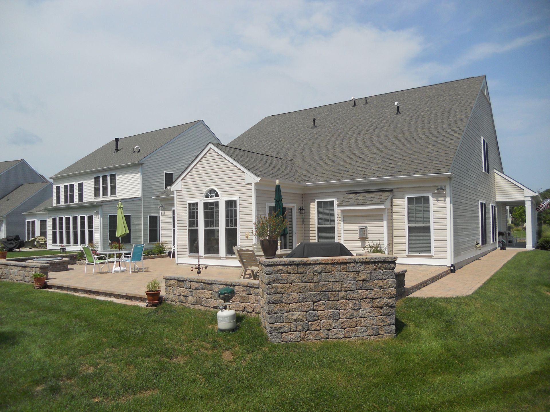 A large white house with a patio in front of it