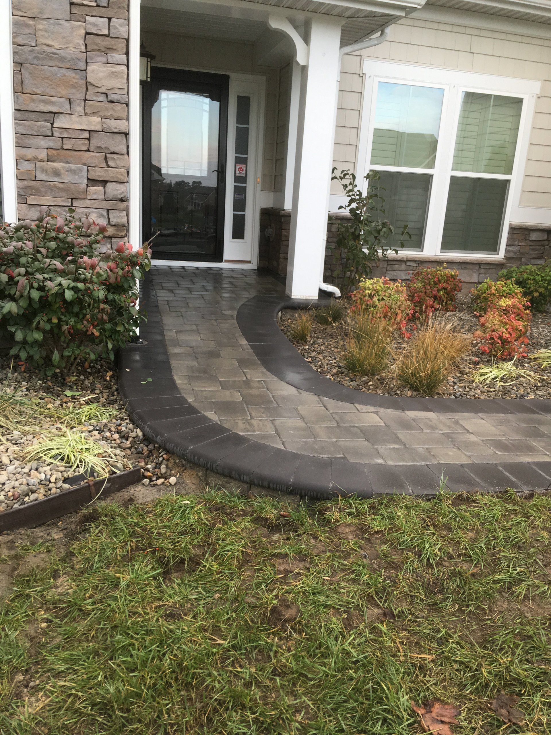 A walkway leading to the front door of a house.