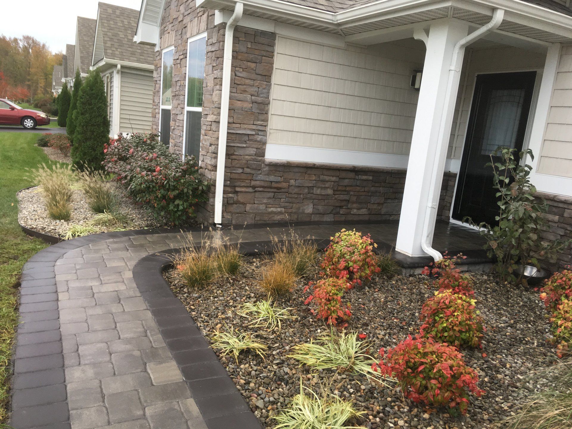 There is a walkway leading to the front of a house.