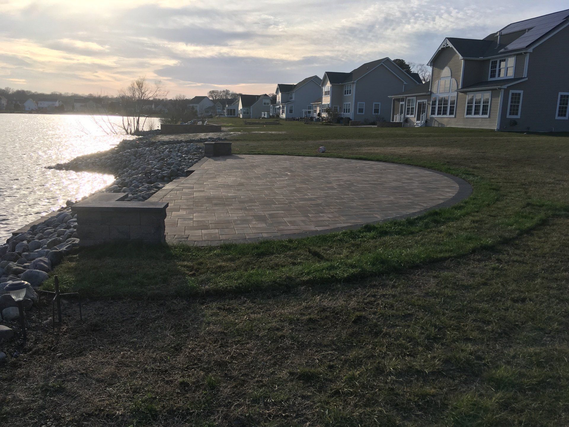 A row of houses sitting next to a body of water.