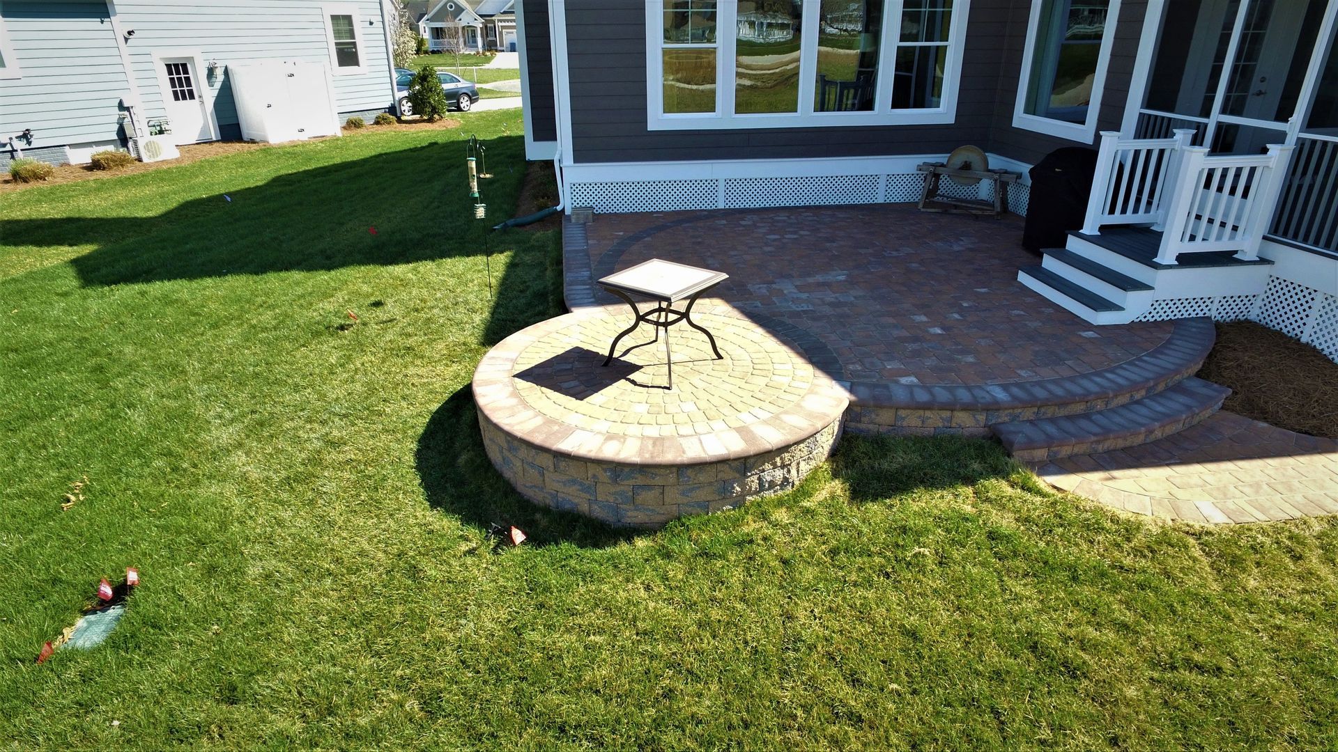 An aerial view of a fire pit in the backyard of a house.