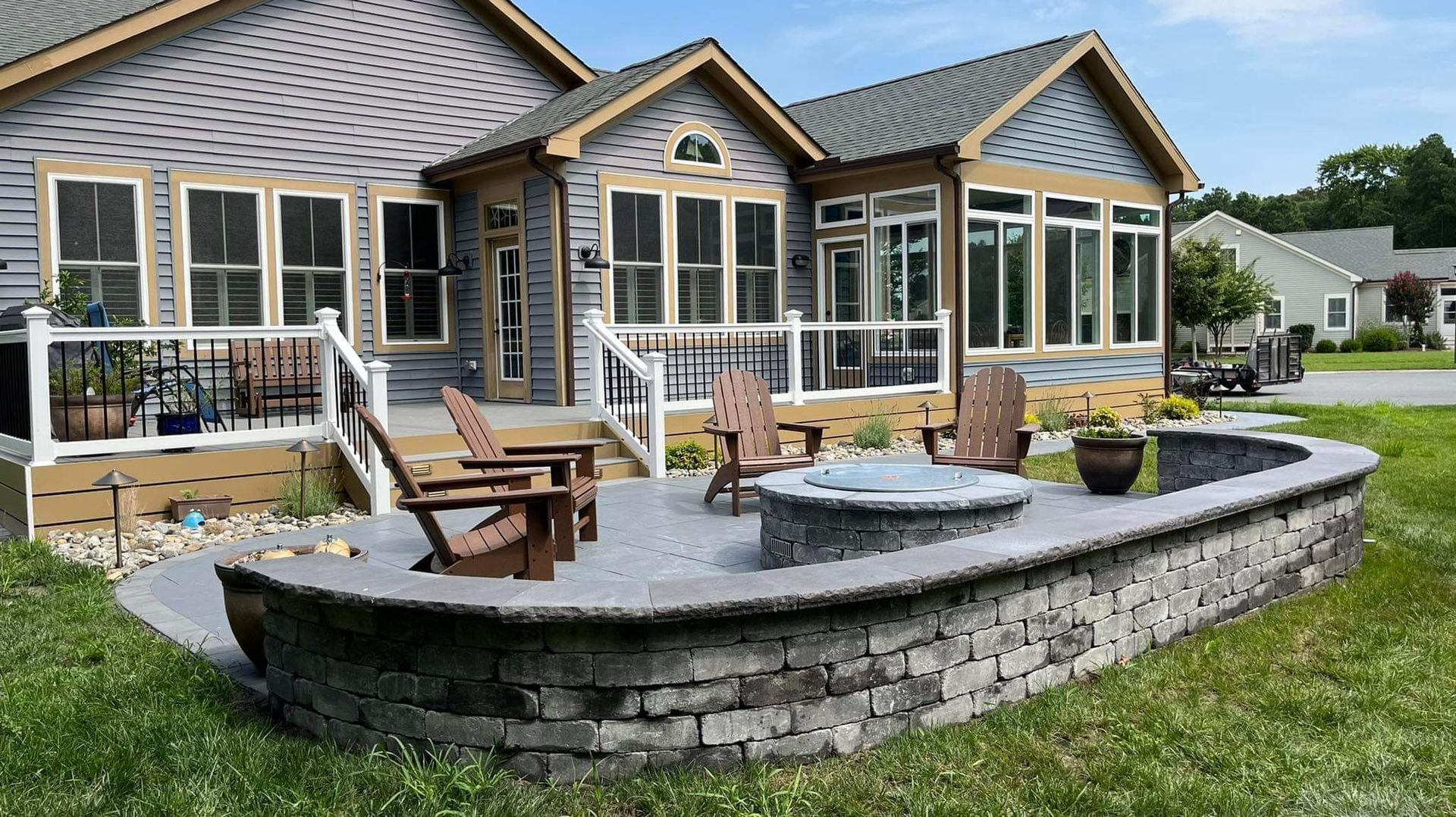 A large house with a fire pit in front of it.