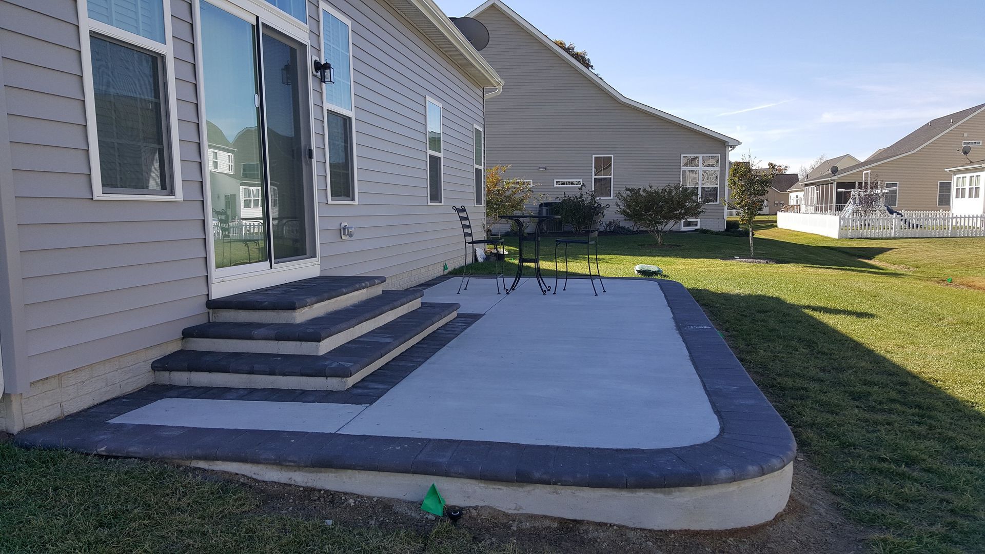 A house with a patio and stairs in front of it.