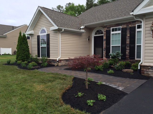 A house with a walkway leading to the front door