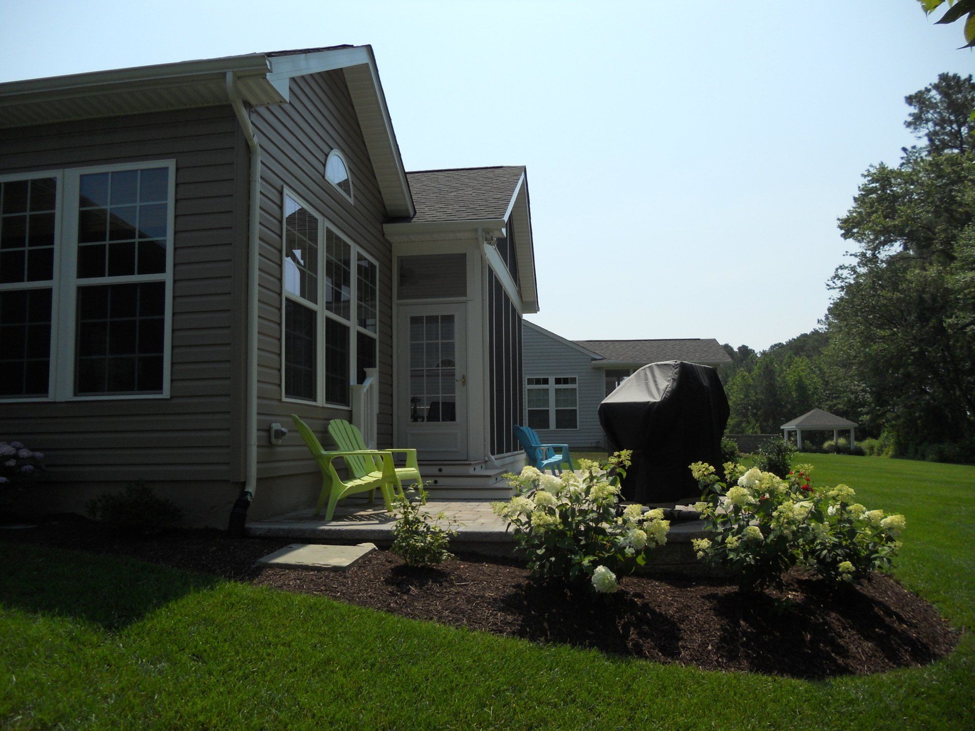 A house with a patio and chairs in front of it