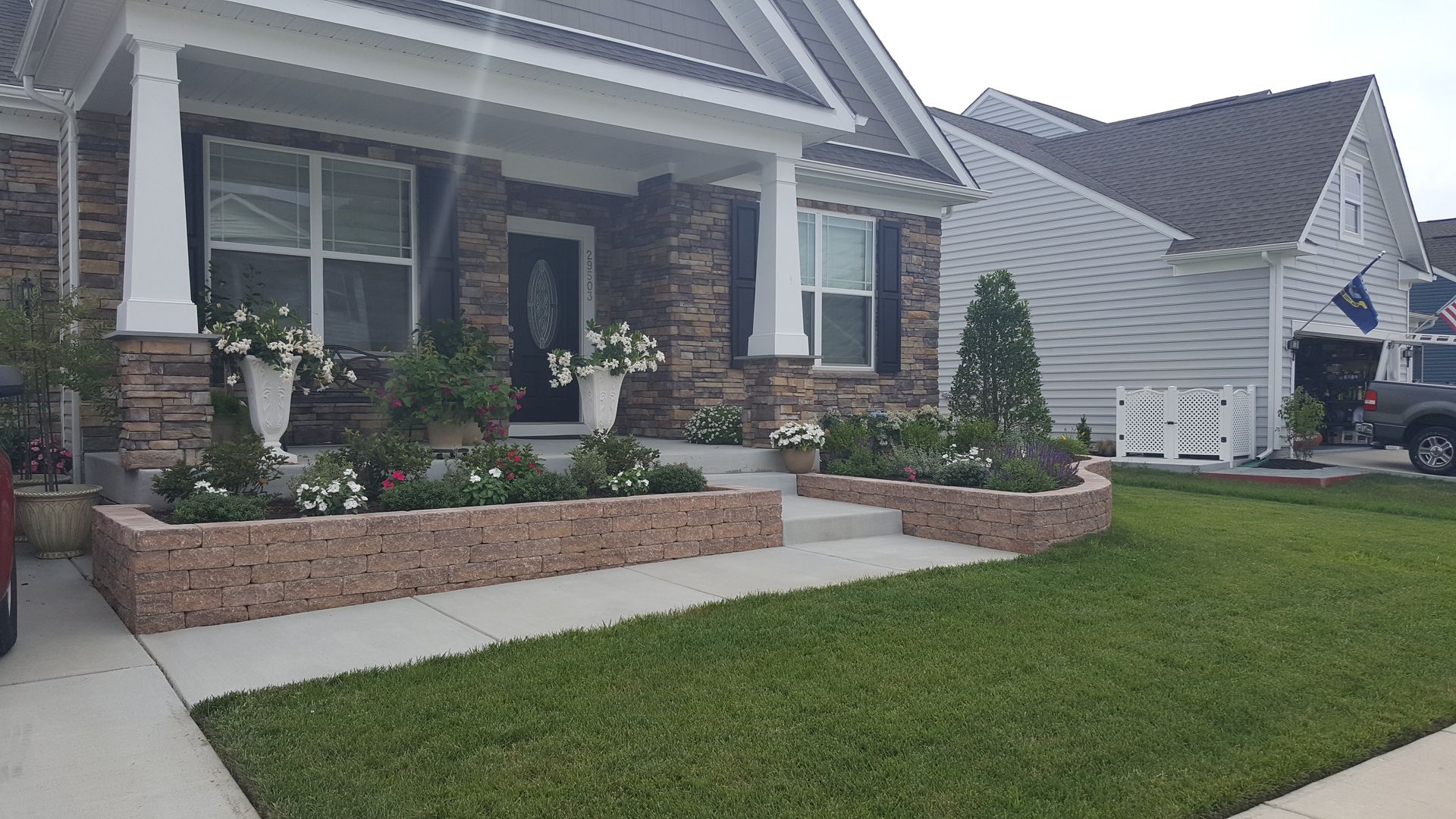 A brick house with a lush green lawn in front of it.