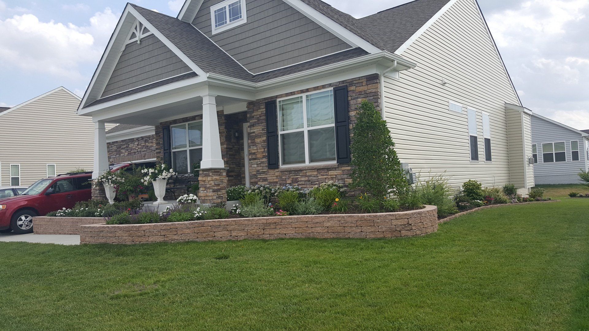 A house with a car parked in front of it.