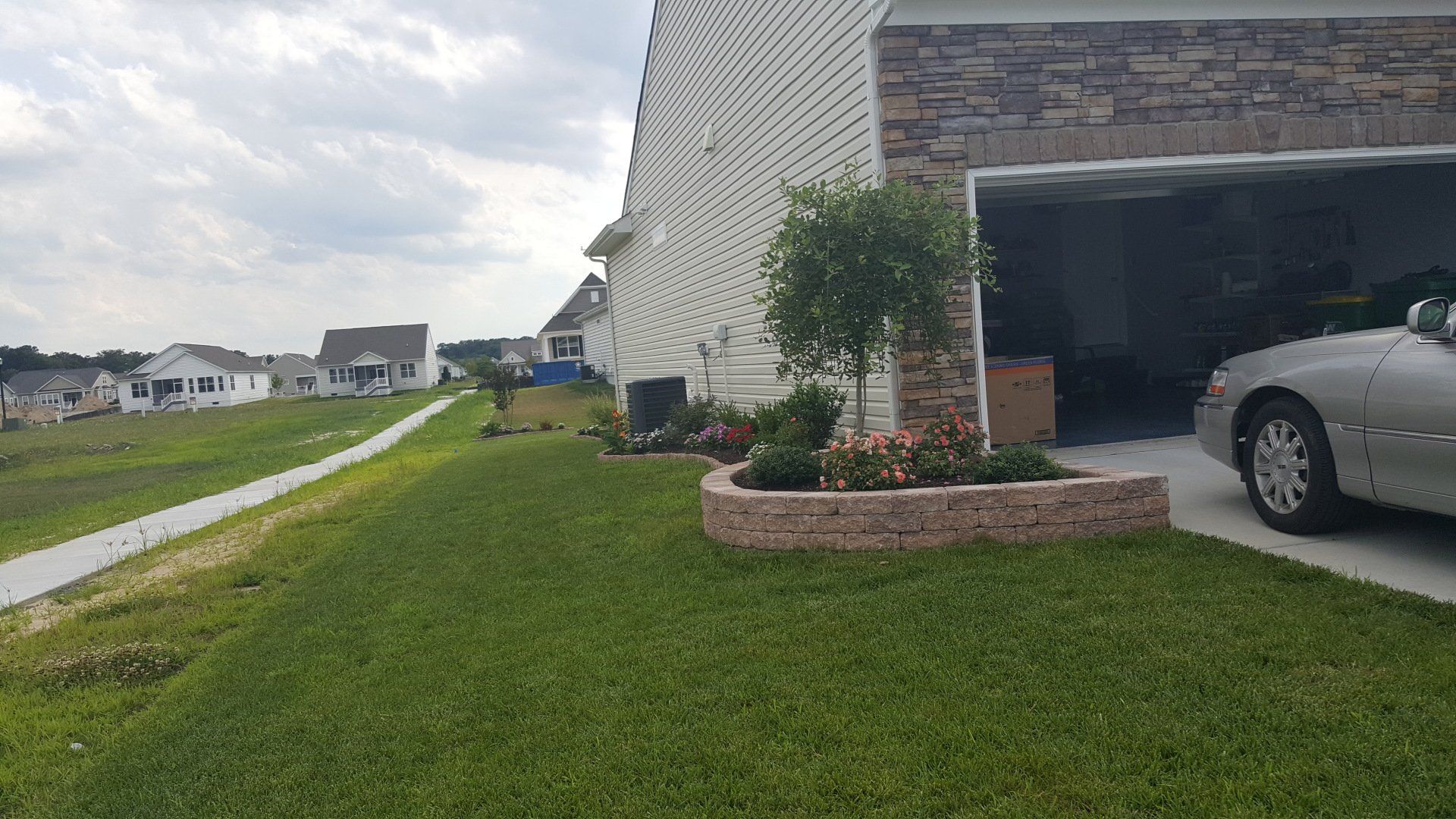 A car is parked in front of a house in a residential area.