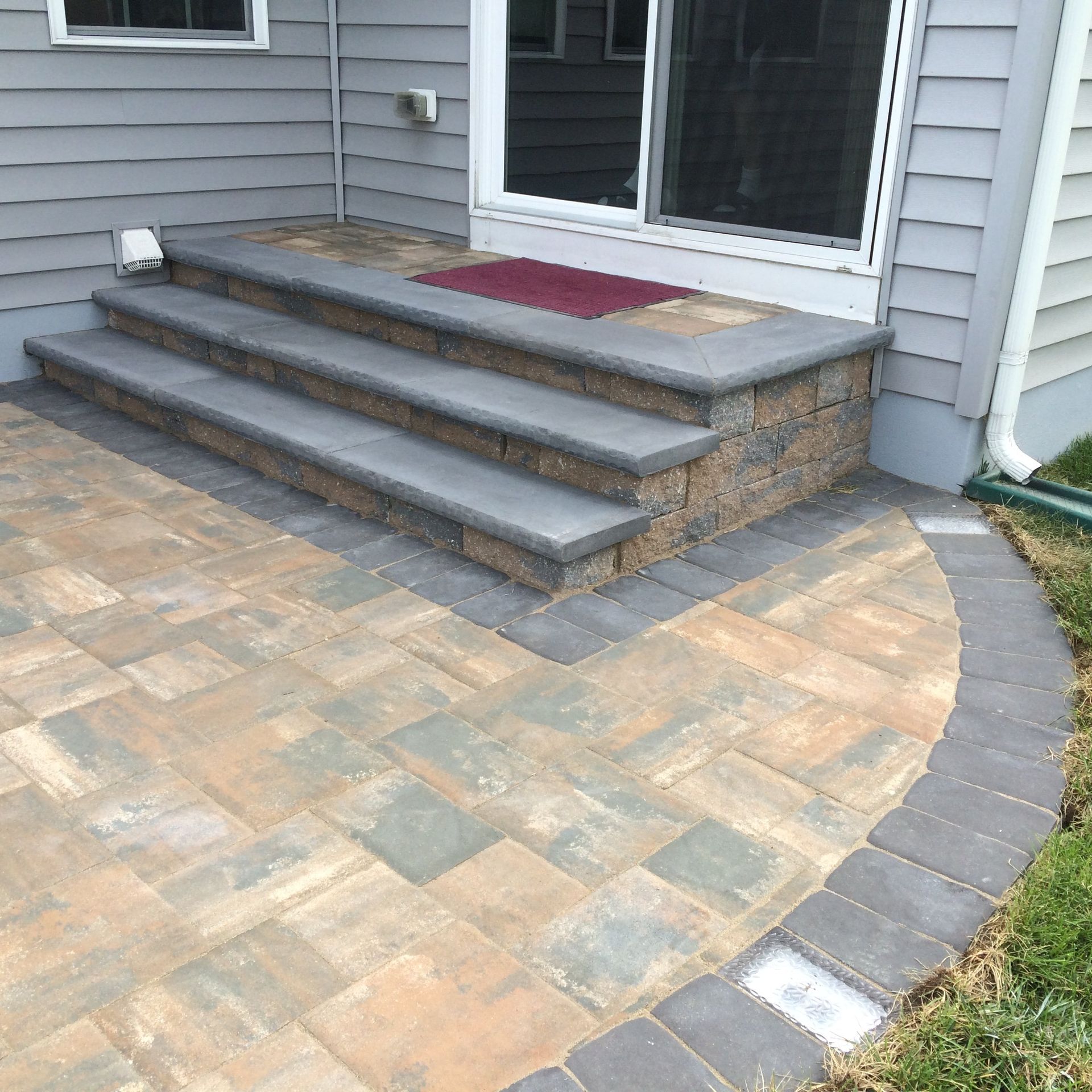 A patio with steps leading up to a house