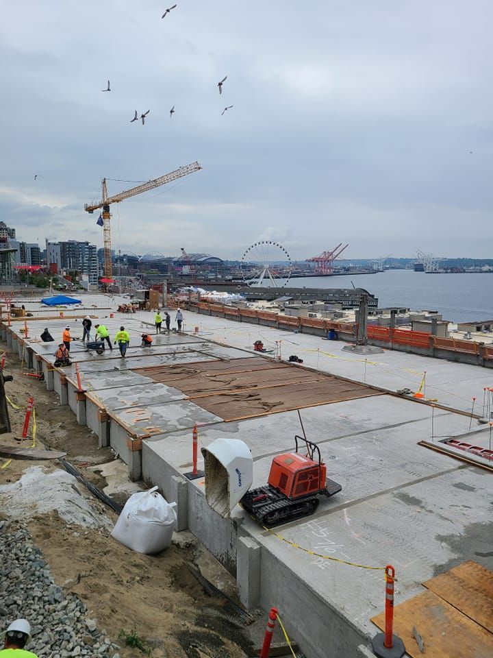 A construction site with a large body of water in the background.