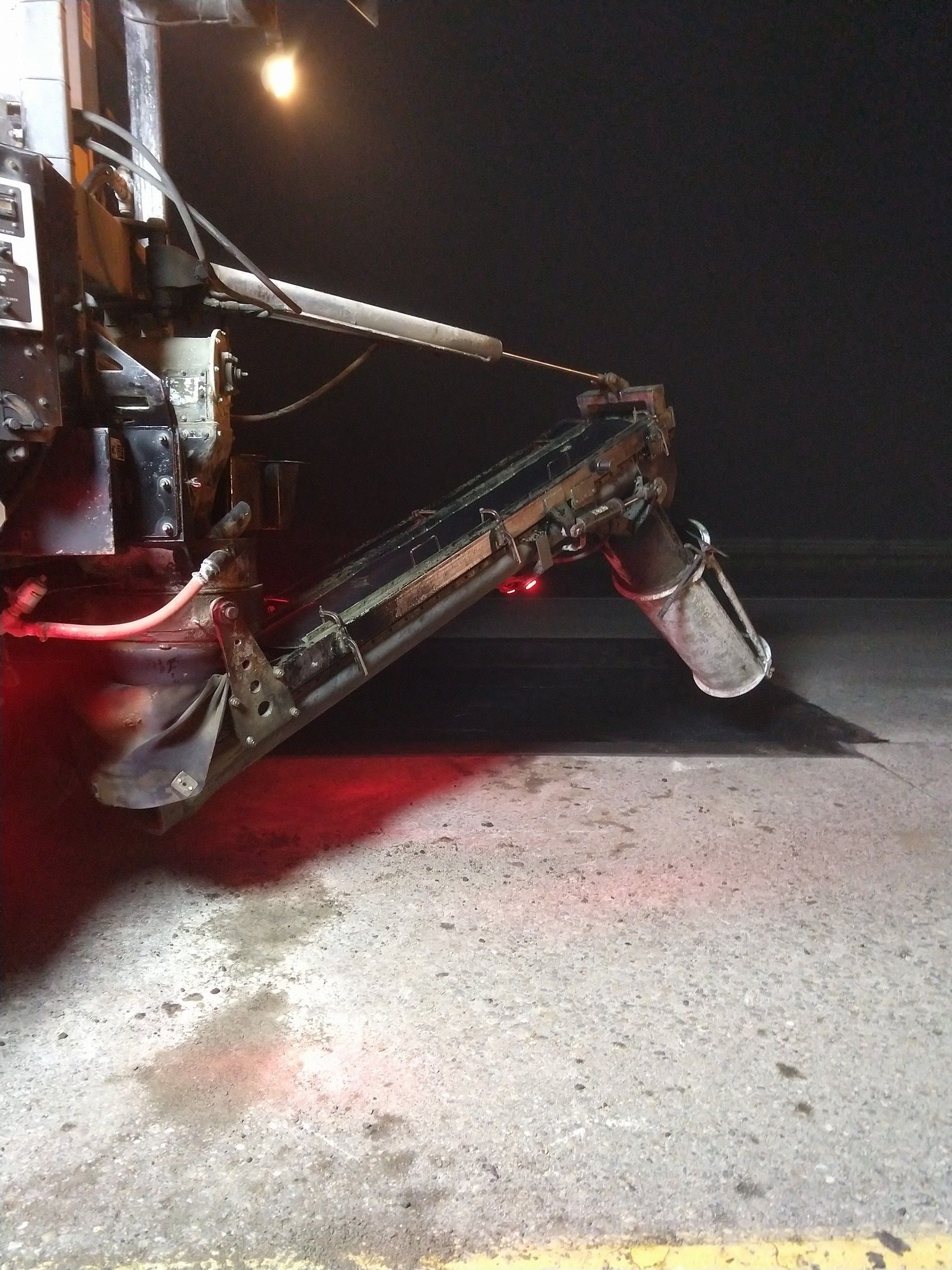 A machine is sitting on the ground at night.