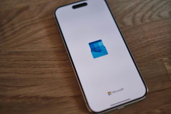 A microsoft phone is sitting on a wooden table.