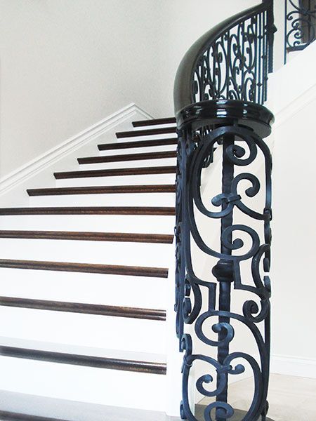A staircase with white steps and a black railing