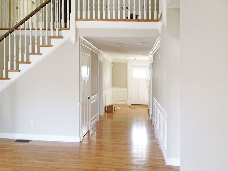 An empty hallway with stairs leading up to the second floor