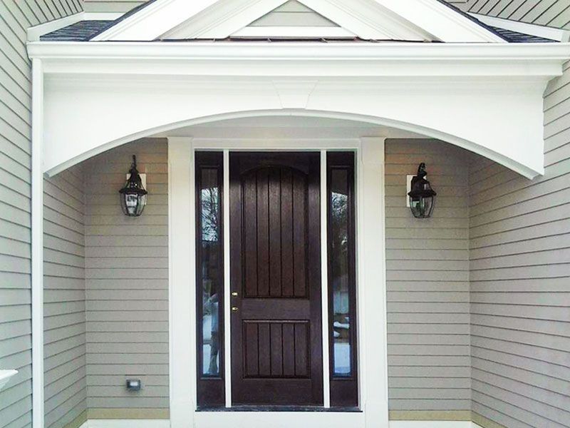 The front door of a house has a canopy over it