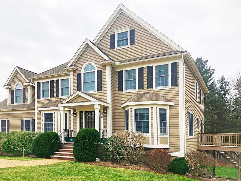 A large house with a lot of windows and black shutters