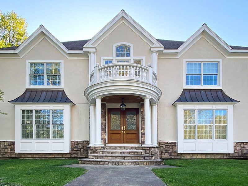 A large house with a balcony and many windows