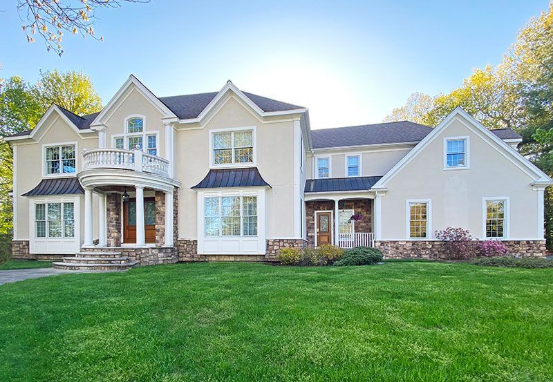 A large house with a lush green lawn in front of it.