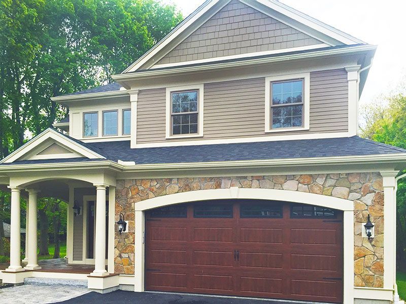 A large house with a large brown garage door