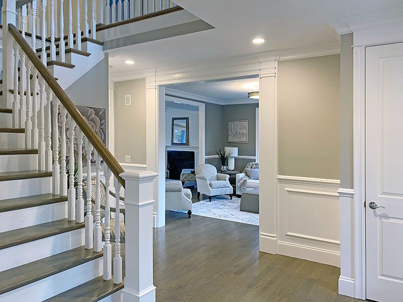 A hallway with stairs leading up to the second floor of a house