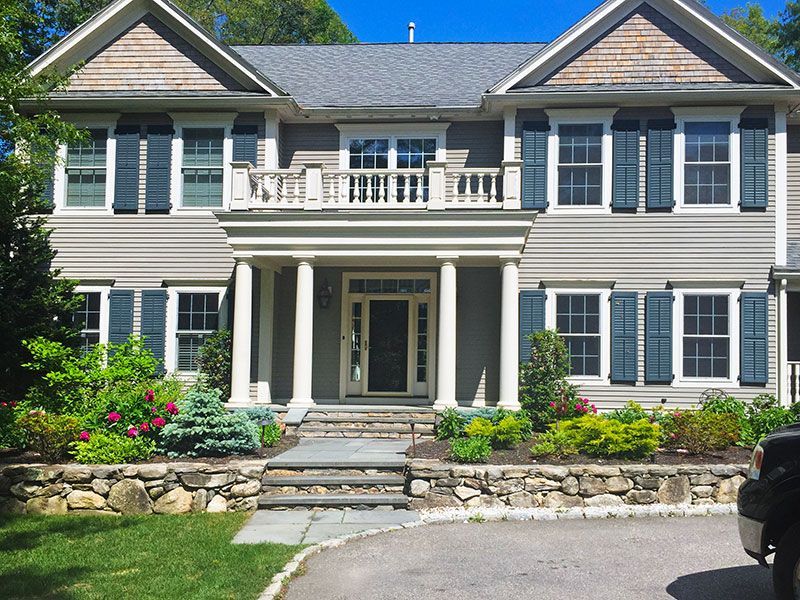A large house with a car parked in front of it