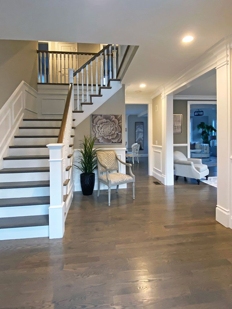 A hallway with stairs leading up to the second floor of a house.
