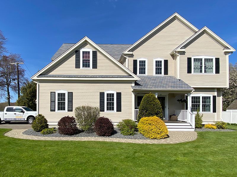 A large house with a truck parked in front of it.