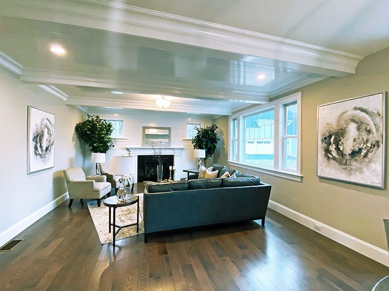 A living room with a couch , chairs , and a fireplace.