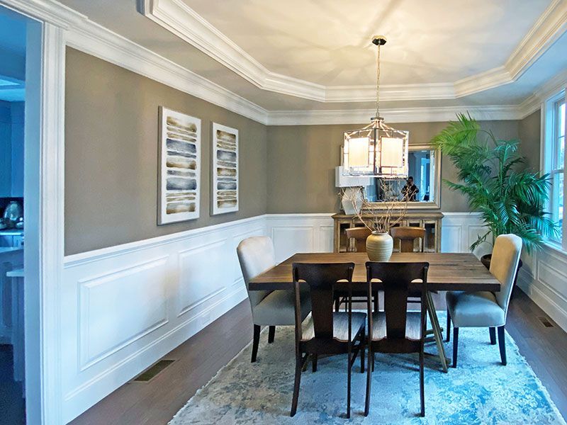 A dining room with a table and chairs and a chandelier.