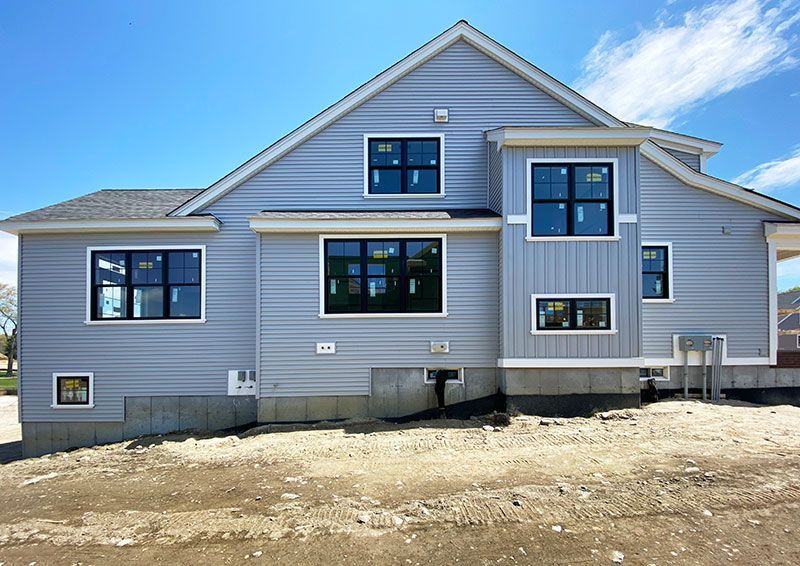A large house with a lot of windows is being built.