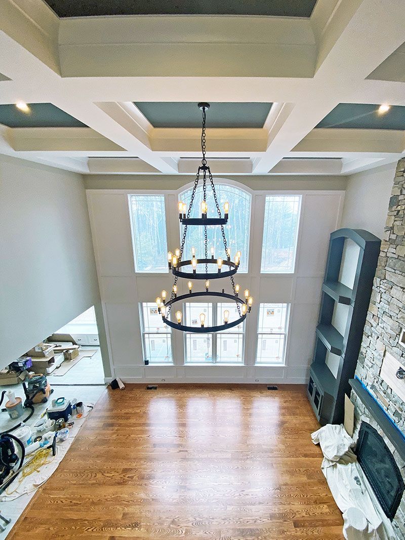 An aerial view of a living room with a chandelier hanging from the ceiling.