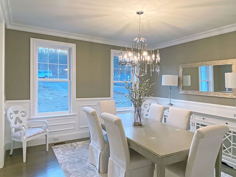 A dining room with a table and chairs and a chandelier.