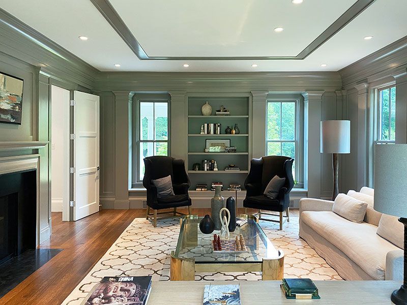 A living room with a couch and chairs and a fireplace
